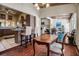 Kitchen nook with brick-laid floors and view to kitchen and dining areas at 1808 Coquina Dr, Sarasota, FL 34231