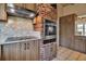 Modern kitchen featuring wood cabinetry, stainless steel appliances and brick column at 1808 Coquina Dr, Sarasota, FL 34231