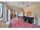 Bright and airy living room features backyard views, vintage rug and work space at 1808 Coquina Dr, Sarasota, FL 34231
