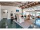 Inviting living room featuring a vaulted ceiling, a cozy fireplace, neutral decor, and eye-catching green tile floors at 1808 Coquina Dr, Sarasota, FL 34231