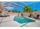 Beautiful screened-in pool featuring clear water, manicured landscaping, and comfortable lounge chairs at 1808 Coquina Dr, Sarasota, FL 34231