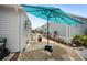 Charming backyard patio with a shade umbrella and cozy seating at 2107 Palma Sola Blvd # 7, Bradenton, FL 34209