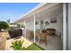 Relaxing carport area with outdoor seating and a grill at 2107 Palma Sola Blvd # 7, Bradenton, FL 34209