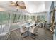 Sunroom dining area with a modern table, seating for six, and ample natural light at 2107 Palma Sola Blvd # 7, Bradenton, FL 34209