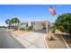 Inviting one-story home with a carport, featuring an American flag and manicured landscaping at 2107 Palma Sola Blvd # 7, Bradenton, FL 34209
