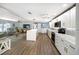 Open concept kitchen with an island, seamlessly connecting to the cozy living area at 2107 Palma Sola Blvd # 7, Bradenton, FL 34209