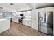 Spacious kitchen with white cabinets, stainless steel appliances, and modern countertops at 2107 Palma Sola Blvd # 7, Bradenton, FL 34209