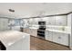 Modern kitchen featuring stainless steel appliances, island seating, and bright lighting at 2107 Palma Sola Blvd # 7, Bradenton, FL 34209