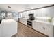 Bright modern kitchen featuring white cabinets, stainless steel appliances, and a center island at 2107 Palma Sola Blvd # 7, Bradenton, FL 34209
