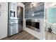 Modern kitchen with stainless steel appliances and a decorative electric fireplace at 2107 Palma Sola Blvd # 7, Bradenton, FL 34209
