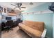 Office with hardwood-look floors, fan, desk, shelving, and a futon providing workspace and relaxation at 2107 Palma Sola Blvd # 7, Bradenton, FL 34209