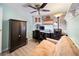 Office space featuring wood-look floors, ceiling fan, desk, shelving, and storage cabinet with a futon at 2107 Palma Sola Blvd # 7, Bradenton, FL 34209
