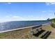 A beautiful water view showing a park bench for enjoying the ocean breeze and stunning views at 2107 Palma Sola Blvd # 7, Bradenton, FL 34209