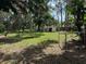 Picturesque backyard featuring mature trees, a rope swing, and a storage shed at 2311 W 52Nd Ave Drive, Bradenton, FL 34207