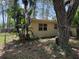 Backyard featuring mature trees, surrounding greenery, and a peek at the rear of the home at 2311 W 52Nd Ave Drive, Bradenton, FL 34207