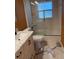 Bright bathroom featuring a white vanity, marble floors, and a shower with a glass door at 2311 W 52Nd Ave Drive, Bradenton, FL 34207