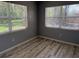 This bedroom features two large windows for natural light and wood-look laminate flooring at 2311 W 52Nd Ave Drive, Bradenton, FL 34207