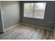 Bright bedroom featuring plank floors and a large window with blinds at 2311 W 52Nd Ave Drive, Bradenton, FL 34207