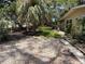 Landscaped front yard featuring a mature palm tree and rock-covered garden beds at 2311 W 52Nd Ave Drive, Bradenton, FL 34207