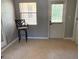 Bright interior room with tile flooring, a bar stool, and a door leading to the outside at 2311 W 52Nd Ave Drive, Bradenton, FL 34207