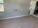 This room features wood-look floors, a window, washer dryer hookups, and a doorway to the kitchen at 2311 W 52Nd Ave Drive, Bradenton, FL 34207