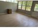 Sunroom with wood-look floors and large windows, perfect for enjoying the outdoors from inside at 2311 W 52Nd Ave Drive, Bradenton, FL 34207