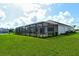 Expansive lawn surrounds this home with a screened-in pool and great privacy at 2469 Paradise Plum Dr, Sarasota, FL 34240