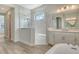Bathroom featuring a glass shower, white cabinets, and wood-look tile floors at 2469 Paradise Plum Dr, Sarasota, FL 34240