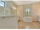 Bright bathroom featuring a soaking tub, glass shower, and wood-look tile floors at 2469 Paradise Plum Dr, Sarasota, FL 34240