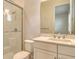 Bathroom with glass shower, toilet, sink and white cabinets at 2469 Paradise Plum Dr, Sarasota, FL 34240