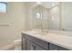 Bathroom featuring vanity with gray cabinetry, white countertop, and a large mirror at 2469 Paradise Plum Dr, Sarasota, FL 34240