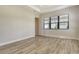 Light and airy bedroom featuring wood-look tile floors and a large window at 2469 Paradise Plum Dr, Sarasota, FL 34240