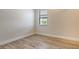 Empty bedroom with one window and wood-look tile floors at 2469 Paradise Plum Dr, Sarasota, FL 34240