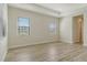 Bright bedroom with tray ceiling, large window, and tile flooring at 2469 Paradise Plum Dr, Sarasota, FL 34240