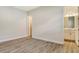 Empty bedroom with wood-look tile floors and a door to the bathroom at 2469 Paradise Plum Dr, Sarasota, FL 34240