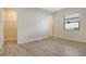 Bedroom with a walk-in closet, window and wood-look tile floors at 2469 Paradise Plum Dr, Sarasota, FL 34240