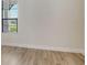 Neutral bedroom features a large window, and wood-look tile flooring at 2469 Paradise Plum Dr, Sarasota, FL 34240