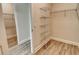 Walk-in closet with wire shelving, wood-look tile floors and white trim at 2469 Paradise Plum Dr, Sarasota, FL 34240
