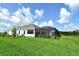 Large backyard view of this beautiful home with a screened-in patio at 2469 Paradise Plum Dr, Sarasota, FL 34240