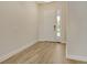 Clean foyer with tile flooring, white trim, and a sidelight by the entry door at 2469 Paradise Plum Dr, Sarasota, FL 34240
