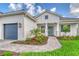 Charming home with a beautifully landscaped yard and a welcoming front entrance with a teal-colored front door at 2469 Paradise Plum Dr, Sarasota, FL 34240