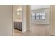 Hallway with a bathroom vanity and a bedroom with large window for natural lighting at 2469 Paradise Plum Dr, Sarasota, FL 34240