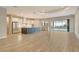 Open-concept kitchen with a large island, stainless steel appliances, and sliding doors to the pool at 2469 Paradise Plum Dr, Sarasota, FL 34240