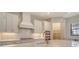 Elegant white kitchen featuring a gas range, a stylish range hood, and ample cabinet space at 2469 Paradise Plum Dr, Sarasota, FL 34240