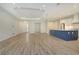 Bright, open-concept kitchen boasts a large island, modern appliances, and wood-look tile flooring at 2469 Paradise Plum Dr, Sarasota, FL 34240