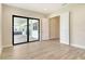 Living room with sliding glass doors to the patio and open doorway to bedroom at 2469 Paradise Plum Dr, Sarasota, FL 34240
