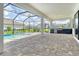 Spacious screened-in patio with an outdoor kitchen, a built-in grill, and a view of the pool at 2469 Paradise Plum Dr, Sarasota, FL 34240