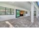 Open patio featuring brick pavers and a view of the kitchen through sliding glass doors at 2469 Paradise Plum Dr, Sarasota, FL 34240