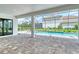Covered patio with stone pavers and a view of the pool at 2469 Paradise Plum Dr, Sarasota, FL 34240