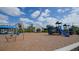 Community playground area featuring swings and a blue play structure on mulch ground covering at 2469 Paradise Plum Dr, Sarasota, FL 34240